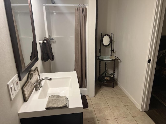 bathroom with a shower with curtain, vanity, and tile patterned flooring