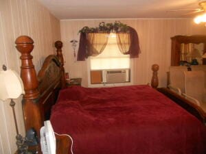 bedroom with a wall unit AC