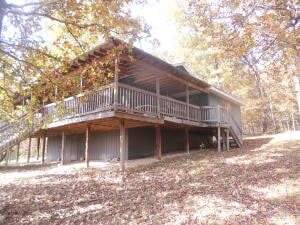 view of property exterior with a wooden deck