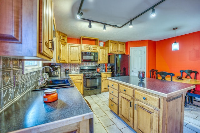 kitchen featuring decorative backsplash, sink, black appliances, light tile patterned floors, and a kitchen island