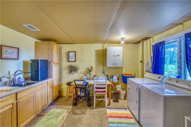 washroom featuring separate washer and dryer and sink