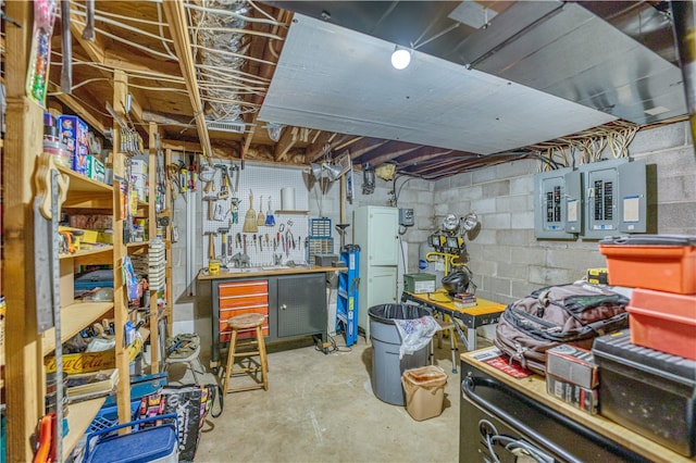 basement with electric panel and a workshop area