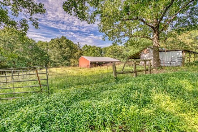 view of yard with an outbuilding and a rural view