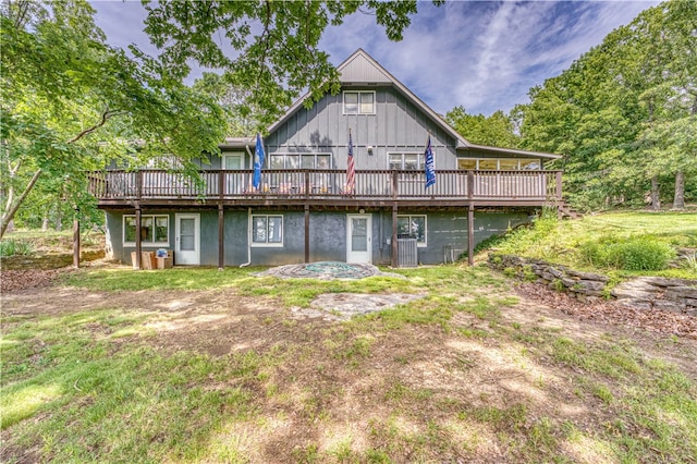 rear view of house with a deck and central AC