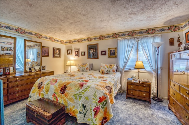 bedroom featuring a textured ceiling and dark carpet