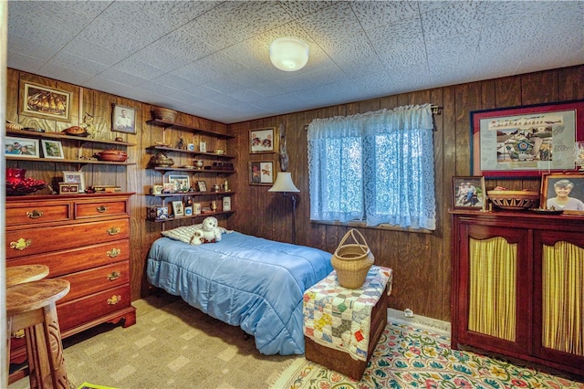 carpeted bedroom with wood walls