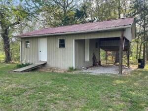 view of outbuilding with a lawn