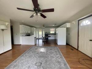 interior space with ceiling fan and dark wood-type flooring