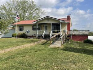 view of front of home with a front yard and a porch