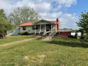 rear view of property with a yard