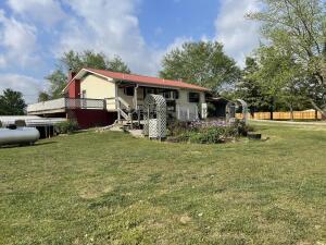 back of property featuring a yard