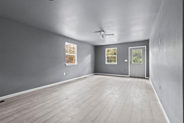 empty room with light hardwood / wood-style floors and ceiling fan