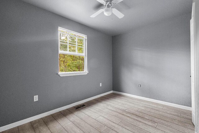 empty room featuring ceiling fan and hardwood / wood-style floors