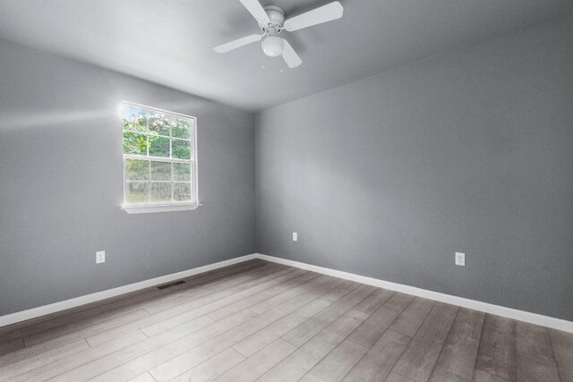 empty room featuring ceiling fan and light wood-type flooring