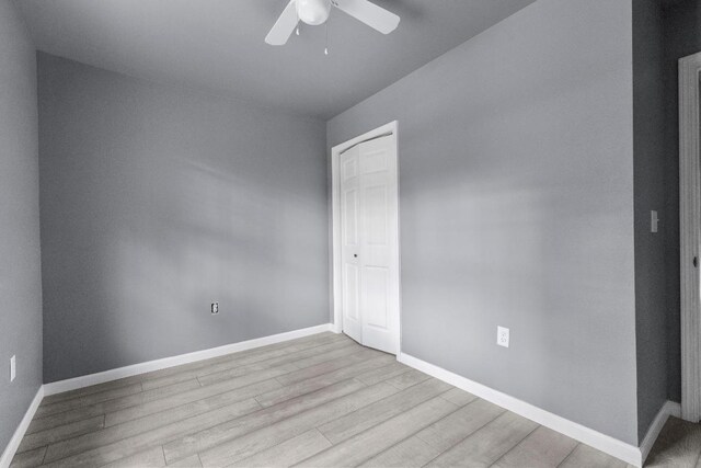 spare room featuring ceiling fan and light wood-type flooring