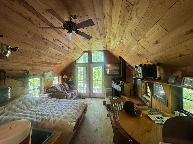 bedroom featuring ceiling fan, wood-type flooring, access to exterior, wooden ceiling, and lofted ceiling