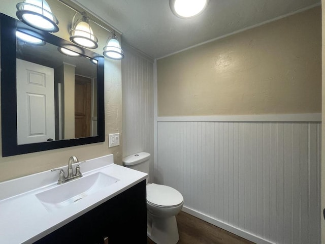 bathroom featuring hardwood / wood-style floors, toilet, and vanity