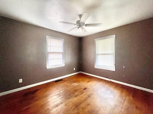 spare room with hardwood / wood-style flooring and ceiling fan