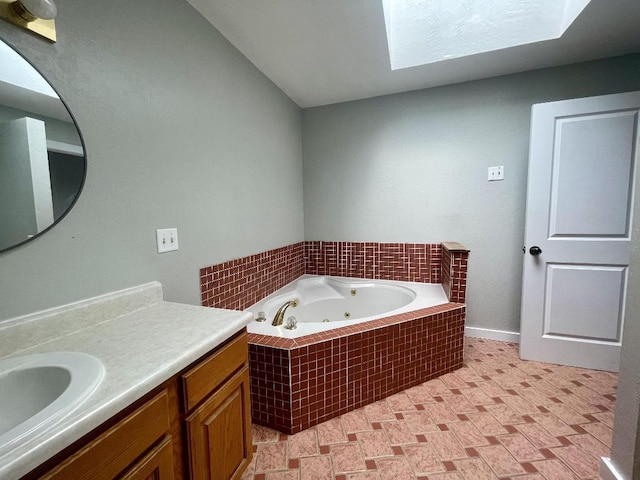 bathroom featuring vanity, a skylight, and a relaxing tiled tub