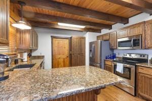 kitchen featuring appliances with stainless steel finishes, wooden ceiling, beamed ceiling, and light stone countertops