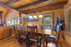 dining room featuring wood ceiling, beamed ceiling, wooden walls, and wood finished floors