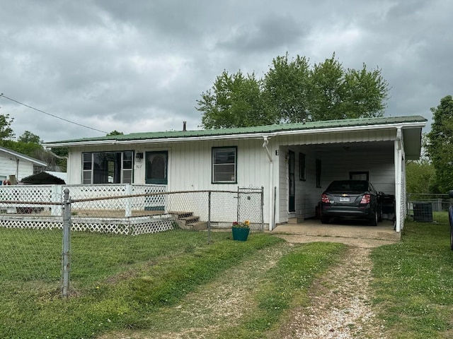 view of front of property with a front lawn, central air condition unit, a carport, and covered porch