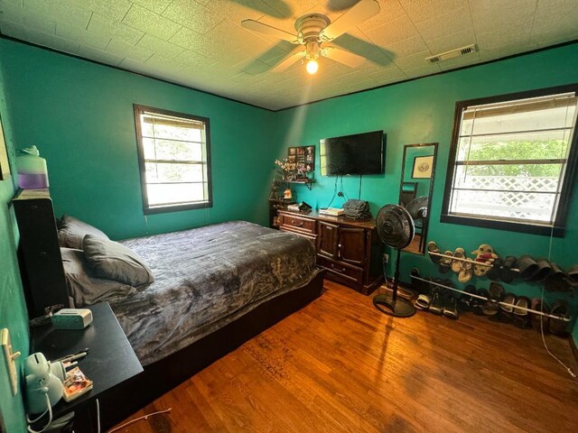 bedroom featuring hardwood / wood-style flooring and ceiling fan