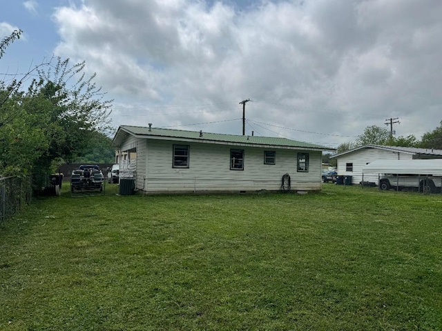 rear view of house with a lawn