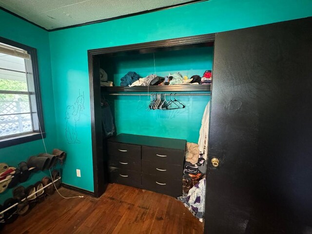 bedroom with dark wood-type flooring