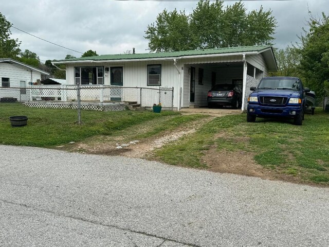 view of front of home featuring a front lawn and a carport