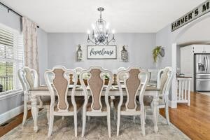 dining area featuring an inviting chandelier and wood-type flooring