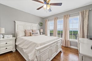 bedroom with ceiling fan and dark hardwood / wood-style flooring