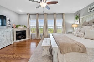 bedroom with hardwood / wood-style floors and ceiling fan