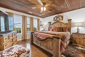 bedroom with ceiling fan, hardwood / wood-style floors, and wood ceiling