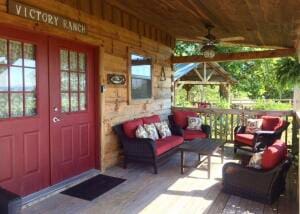 view of exterior entry with ceiling fan and outdoor lounge area