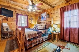 bedroom featuring ceiling fan, beamed ceiling, wooden ceiling, and wood-type flooring