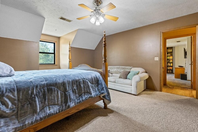 bedroom with a textured ceiling, ceiling fan, and carpet