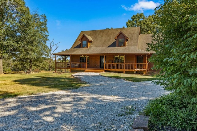 farmhouse inspired home featuring a front yard and covered porch