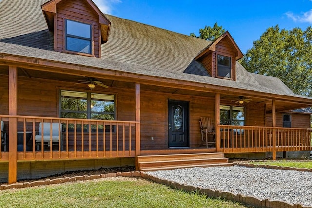 log cabin featuring ceiling fan and a porch