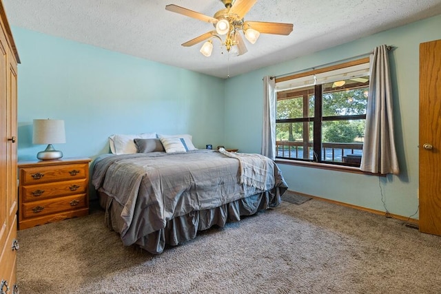 carpeted bedroom with a textured ceiling and ceiling fan