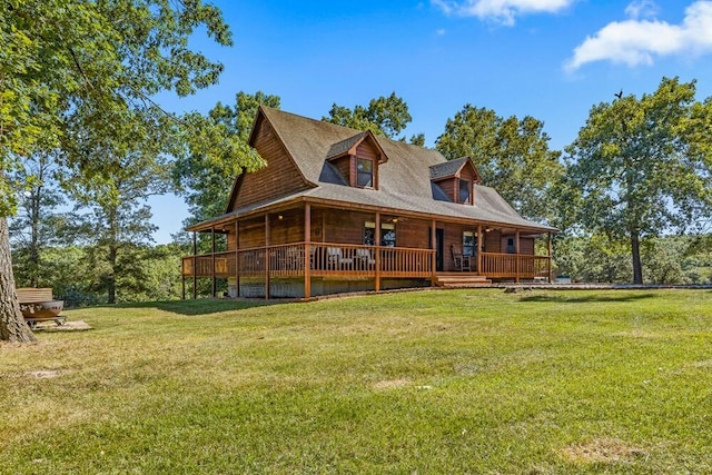 back of property with a lawn and covered porch