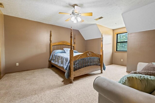 carpeted bedroom featuring a textured ceiling, ceiling fan, and lofted ceiling