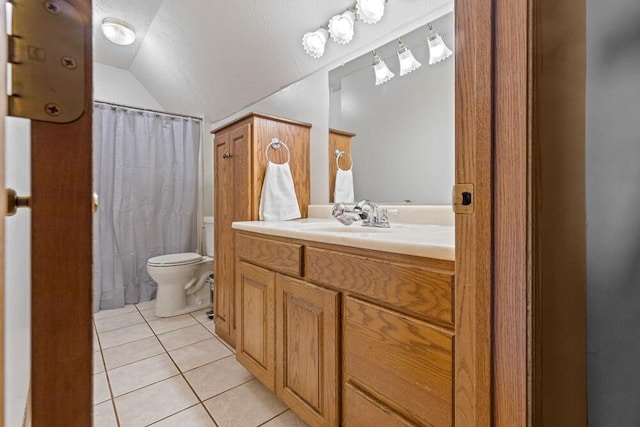 bathroom featuring tile patterned flooring, vaulted ceiling, vanity, and toilet