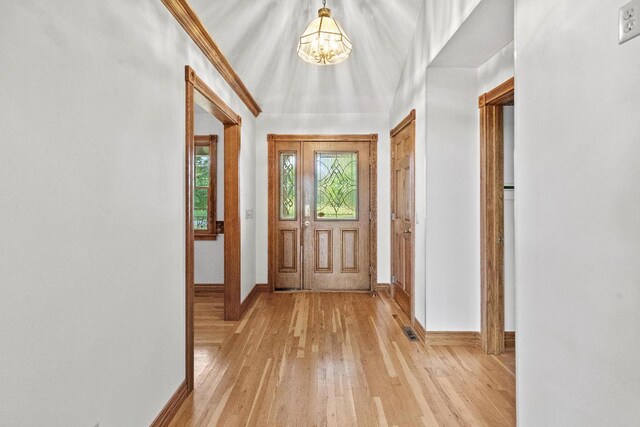 interior space featuring an inviting chandelier and light wood-type flooring