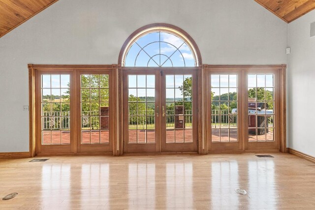 doorway with wooden ceiling, high vaulted ceiling, light hardwood / wood-style flooring, and french doors