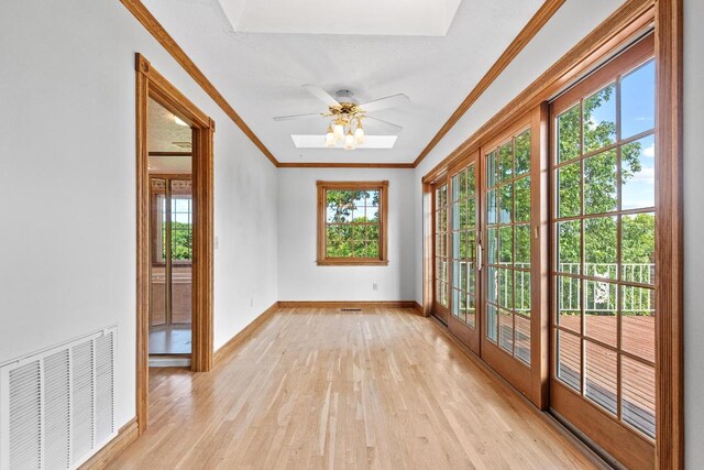 unfurnished sunroom with ceiling fan