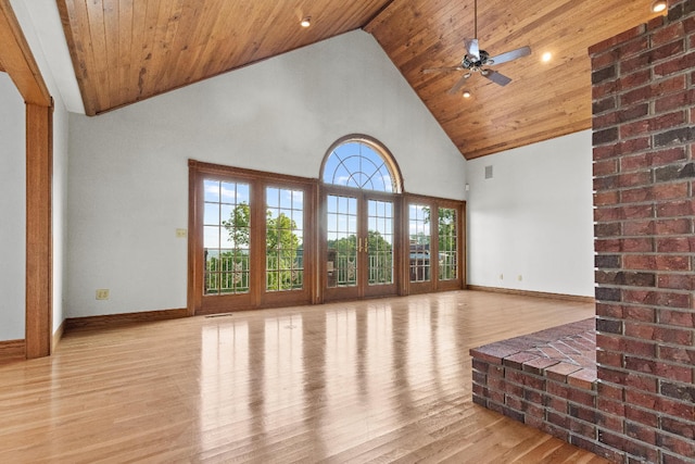 unfurnished living room with light wood-type flooring, high vaulted ceiling, wooden ceiling, and brick wall