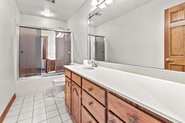 full bathroom featuring enclosed tub / shower combo, toilet, vanity, and tile patterned floors