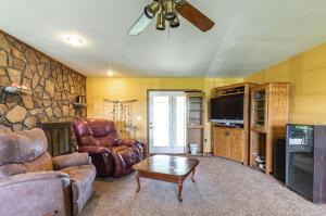 living room featuring ceiling fan, carpet floors, and a fireplace