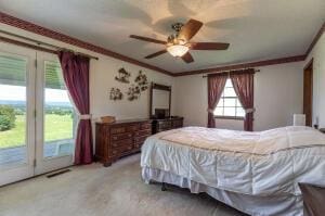 carpeted bedroom with a ceiling fan, access to outside, visible vents, and crown molding